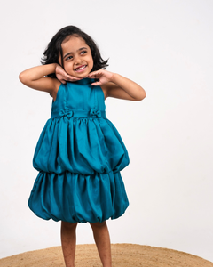 Faye Peacock Blue Tiered Dress with a halter neck, balloon hemline, and two bows on the waist.
