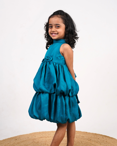 Faye Peacock Blue Tiered Dress with a halter neck, balloon hemline, and two bows on the waist.
