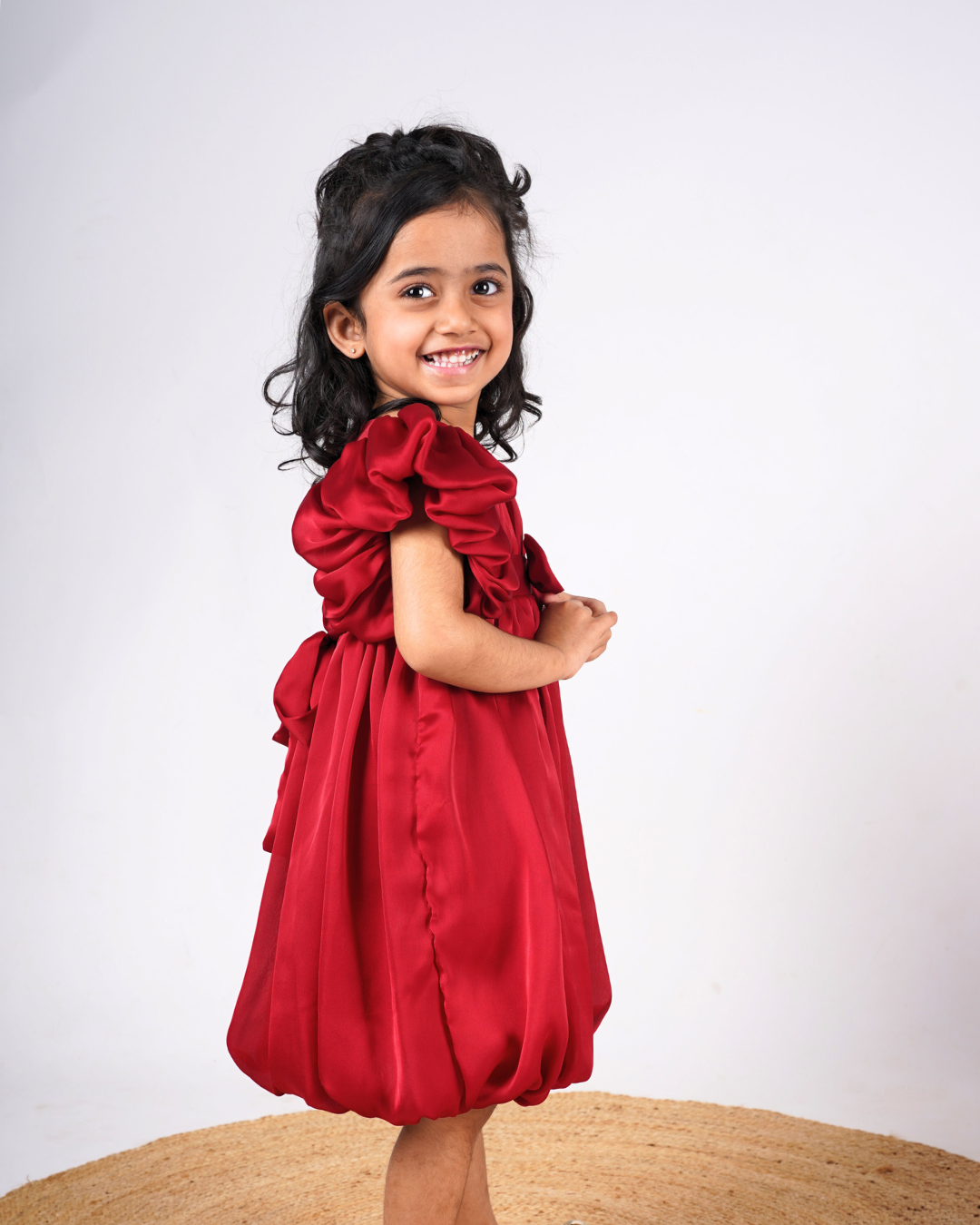 Faye Maroon Puffball Dress with asymmetrical sleeves and a balloon hemline.