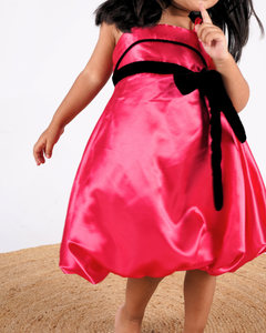 Faye Fuchsia Strappy Dress with a velvet sash and balloon hemline.
