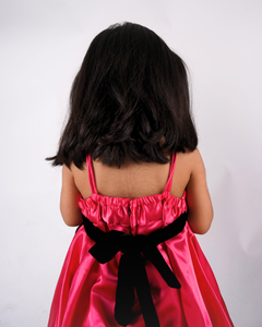 Faye Fuchsia Strappy Dress with a velvet sash and balloon hemline.
