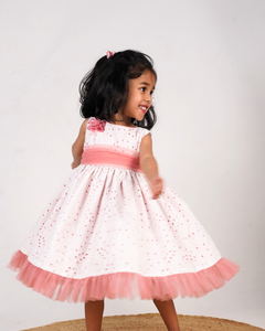 Faye Blush Eyelet Net Peep Out Dress with net frills and a floral bloom.