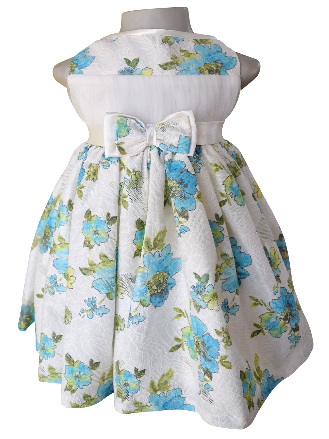 A dress for baby girls from Faye in blue pastel printed floral Lace with satin sash  and double bow.