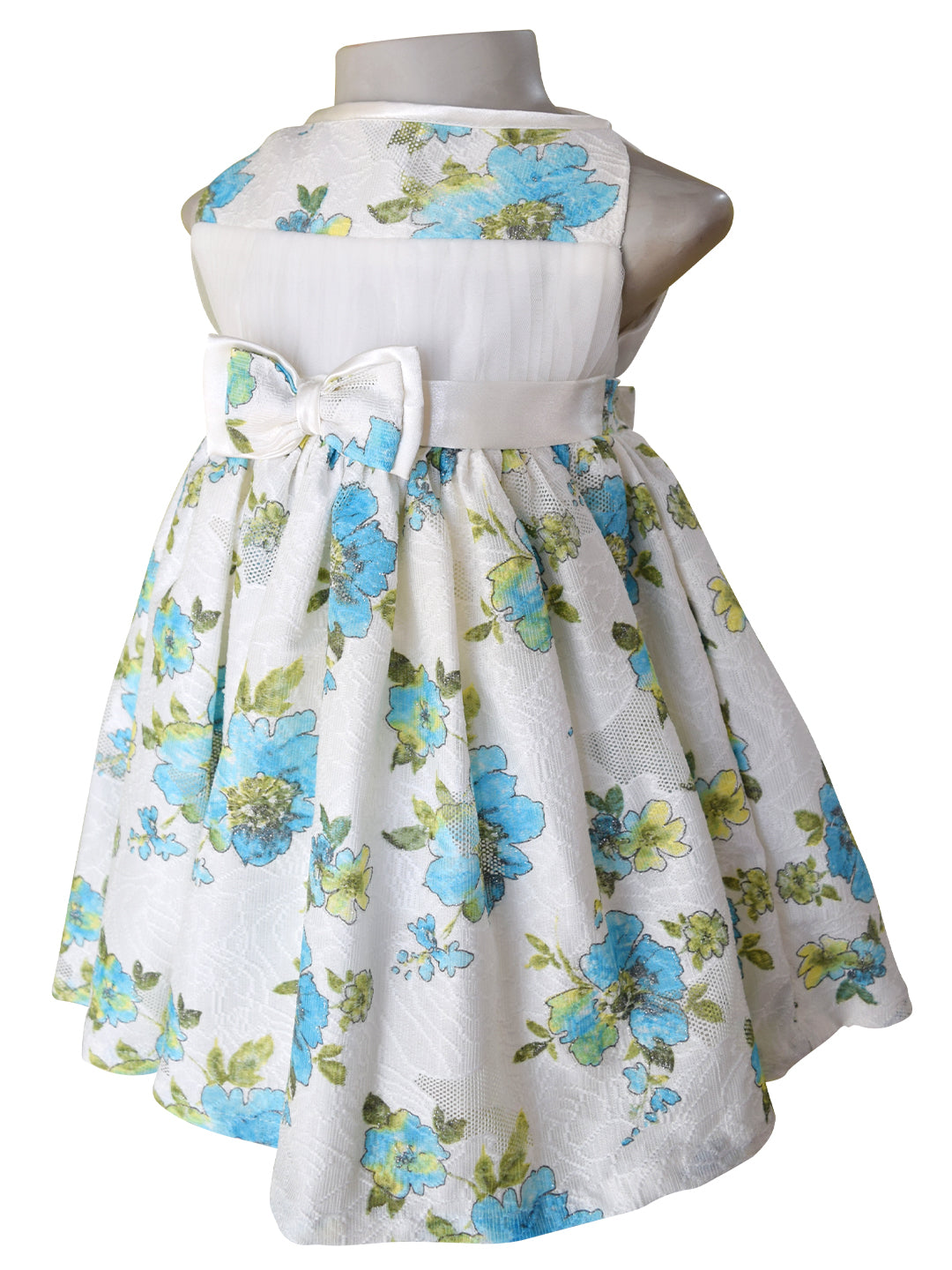 A kids dress in floral pastel printed Lace in blue & green with a satin sash and double bow at the waist