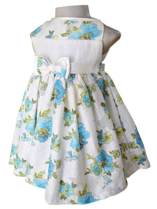 A kids dress in floral pastel printed Lace in blue & green with a satin sash and double bow at the waist