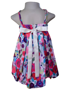 Back side view of a floral satin dress with satin double straps. The dress features watercolour style prints