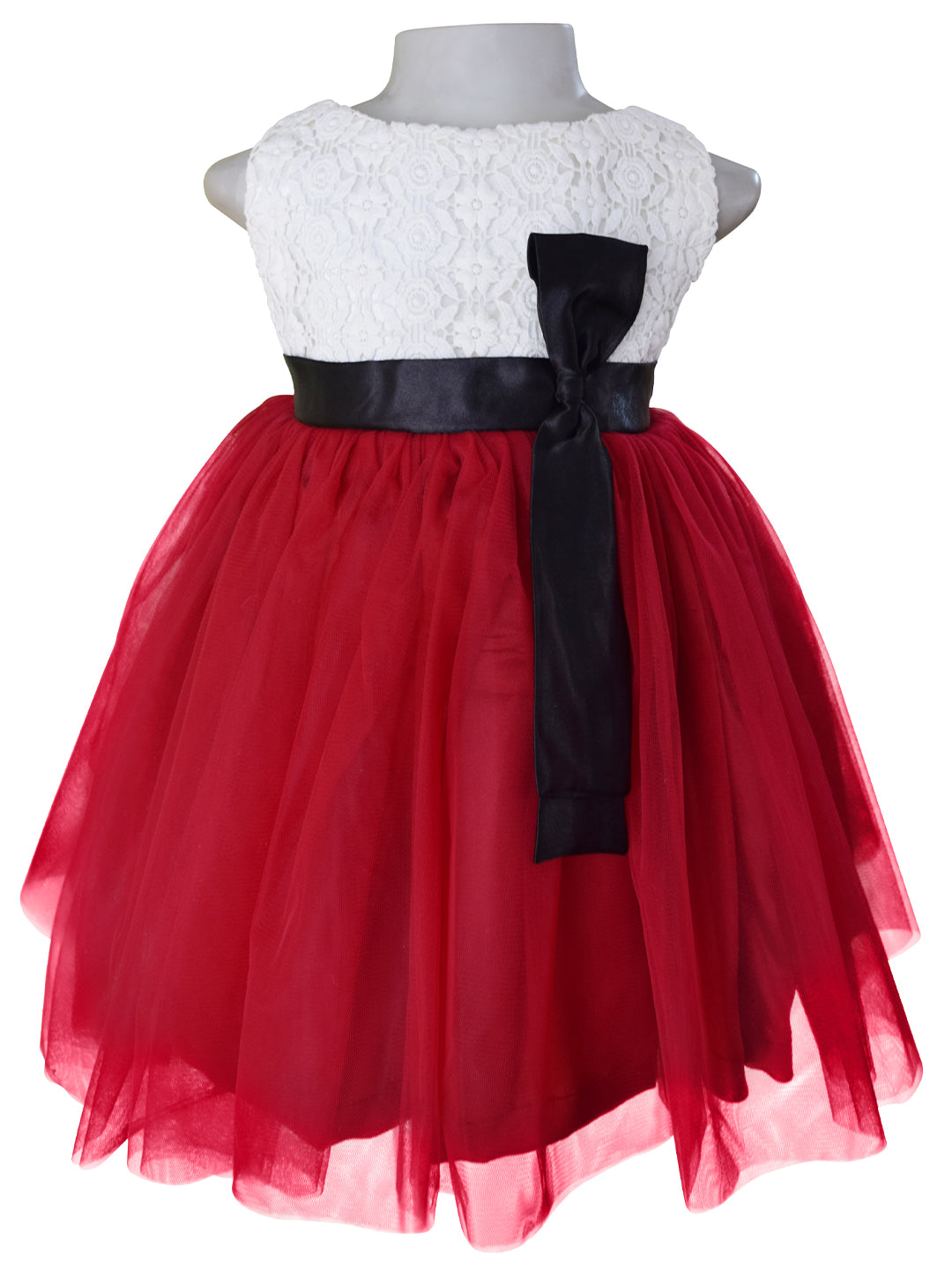 A kids dress with Light Maroon net & Cream Lace bodice with black satin sash & bow