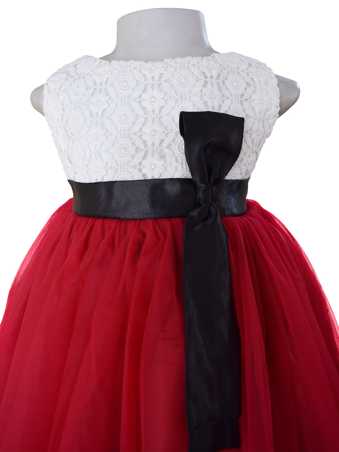 A dress for kid girls with Light Maroon net & Cream Lace bodice with black satin sash & bow