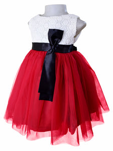 A kids dress with Light Maroon net & Cream Lace bodice with satin sash & bow in black colour at the waist 