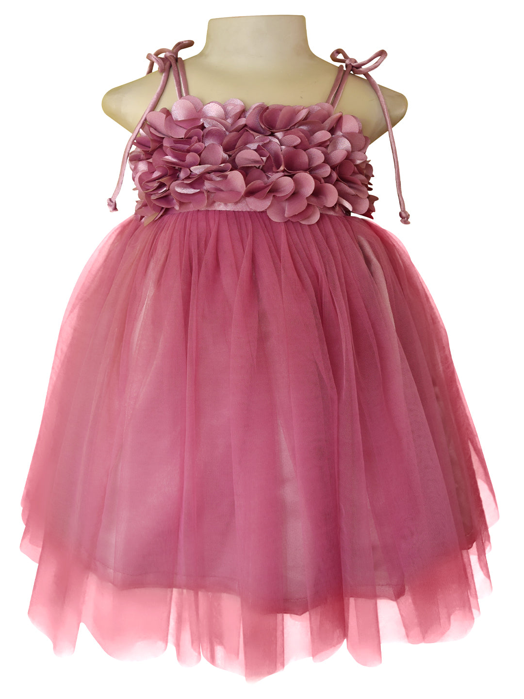 A tutu style girls' party dress in mauve colour. This dress features  bodice with 3D fabric flowers, thin shoulder ties, and a voluminous tulle skirt.