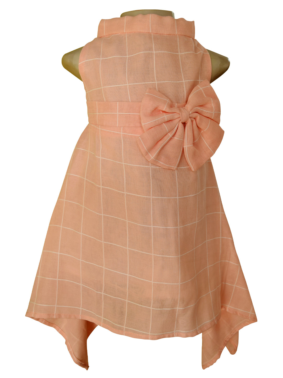 Peach high neck dress with cream checks featuring an empire waistline and an oversized bow
on the side. 