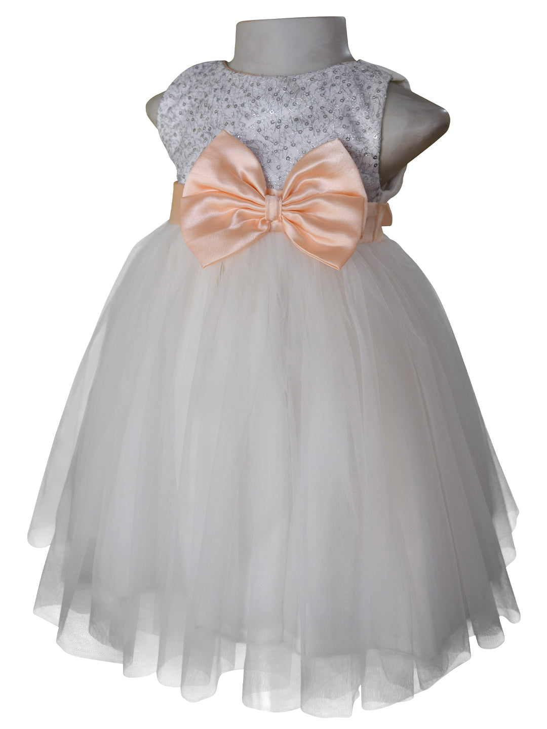A dress for little girls from faye in Silver Sequin bodice and Ivory net with Peach colour sash & bow at the waist