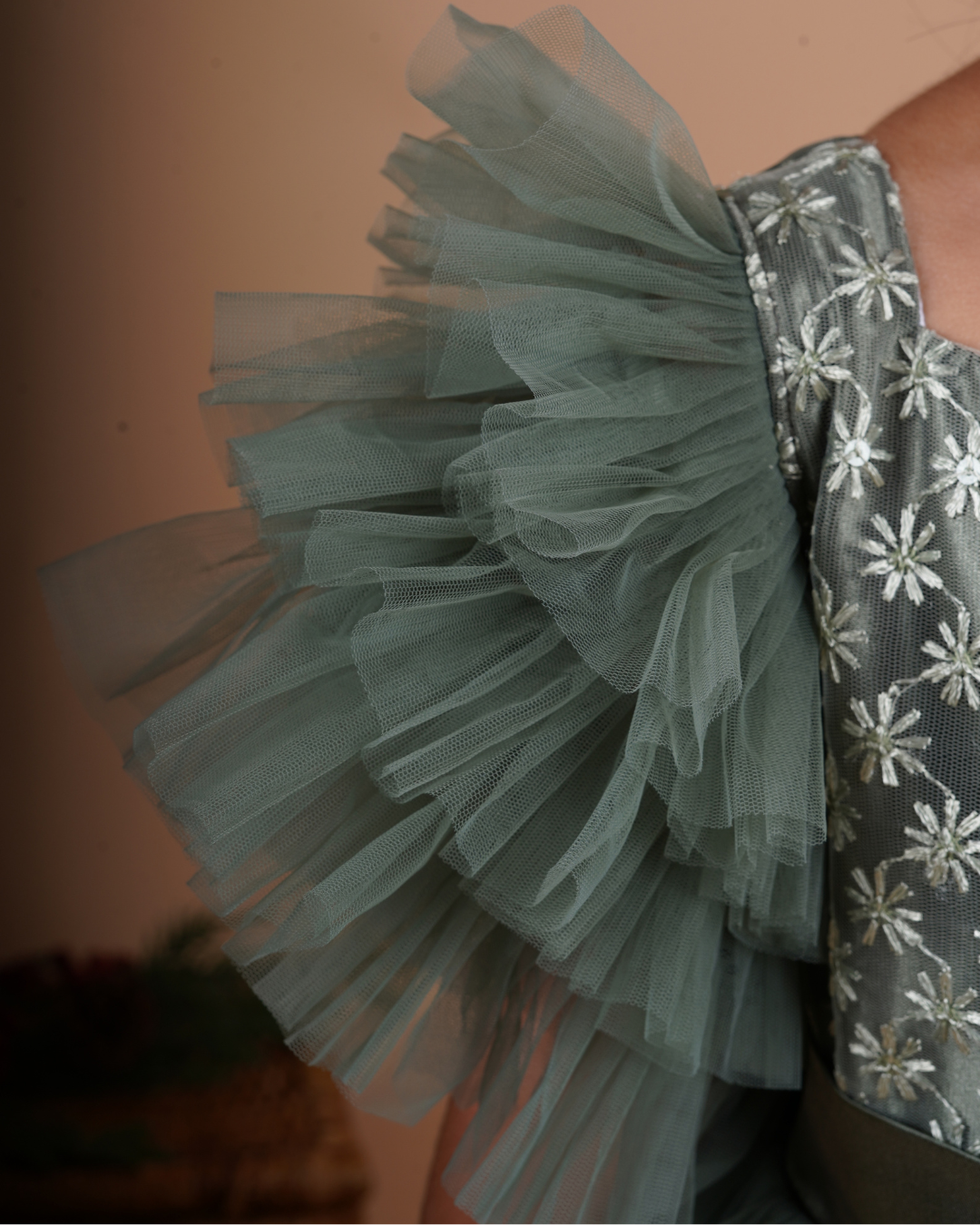 Young girl in the Faye Green Tiered Sleeve Gown