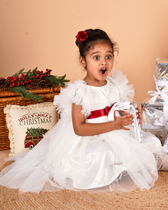 Young girl wearing the Faye Ivory Ruffle Sleeve Dress for Christmas