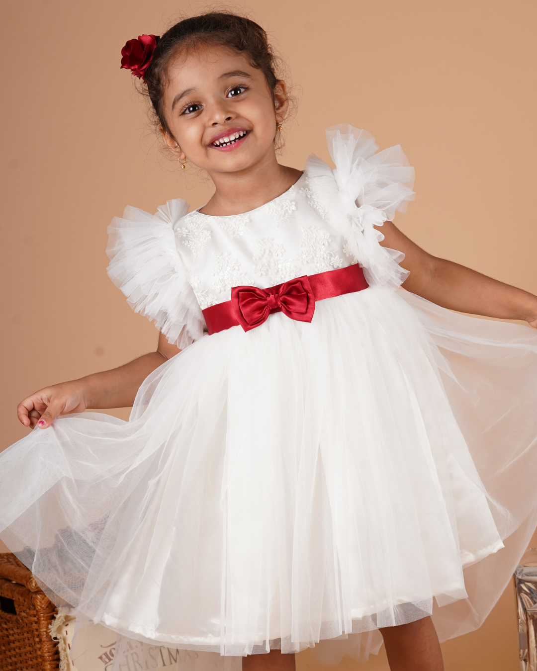 Young girl wearing the Faye Ivory Ruffle Sleeve Dress 