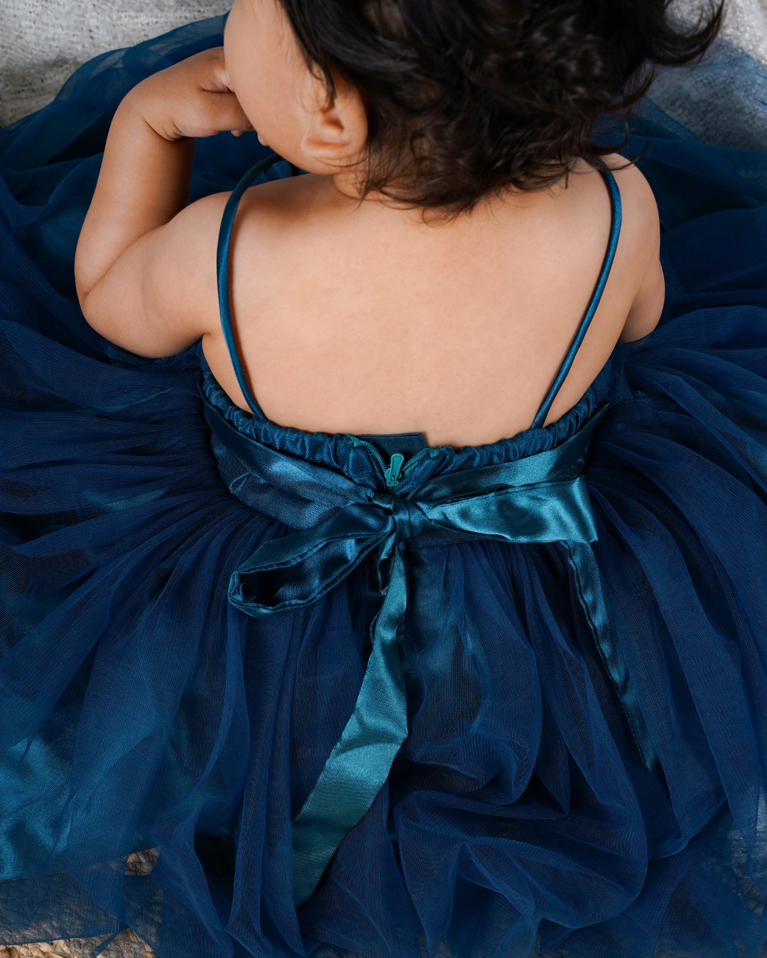 Toddler wearing the Faye Teal Green Asymmetric Dress 